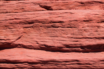 Texture of mountains of red color. Stone rough rough volumetric background, layering. Natural creation, majestic stone wall. The structure and geology of the American mountains. Layout for design.