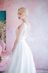 Beautiful elegant bride in a long dress without a veil. The bold image of the bride.