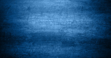 Obraz na płótnie Canvas Design textured sea sand banner tinted with 2020 classic blue trend color with an inscription. The texture of coarse sea sand in classic blue color.