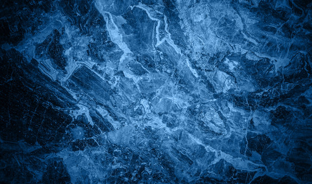 Abstract blue ceramic texture or blue stone surface in dark blue trendy color toned. Deep saturated indigo-navy blue background