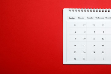 Paper calendar on red background, top view. Space for text