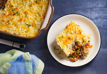 Shepherd's Pie or Cottage Pie on plate, gray backgroud. Overhead horizontal image