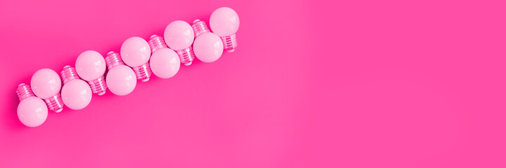 LED lamps and fluorescent lamps on pink background.