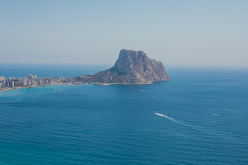 Fototapeta na wymiar Beautiful super wide-angle aerial view of Calpe, Calp, Spain with harbor and skyline, Penon de Ifach mountain, beach and scenery beyond the city, seen from Mirador Monte Toix mountain viewpoint
