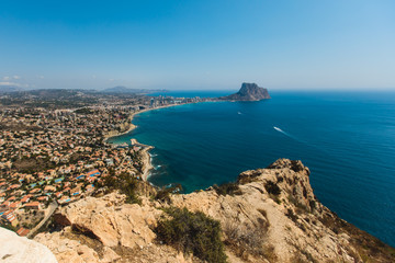 Beautiful super wide-angle aerial view of Calpe, Calp, Spain with harbor and skyline, Penon de Ifach mountain, beach and scenery beyond the city, seen from Mirador Monte Toix mountain viewpoint