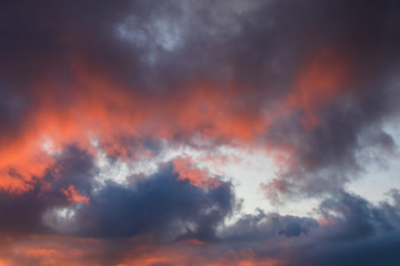 Beautiful sunset sky. Clouds illuminated by red sunlight at sunset. This view of the sky with clouds at sunset is great for background and design.