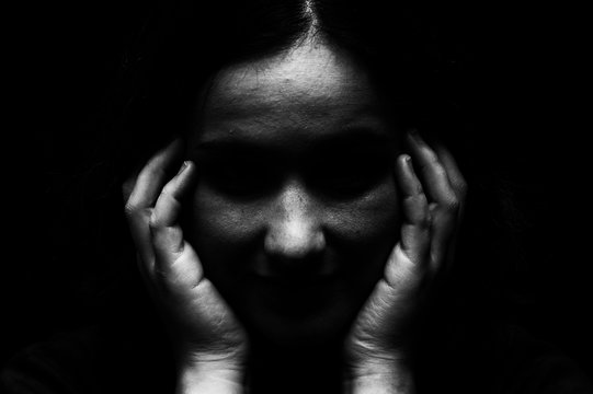 High contrast image of disturbed emotionally overcome mentally unbalanced woman