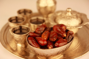 Antique silver pitcher and coffee cup set with dates in a tray isolated on a white background - horizontal