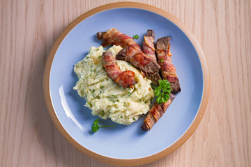 Lamb liver wrapped in bacon with mash potato. View from above, top