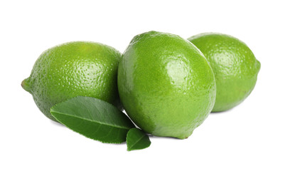 Fresh ripe limes with green leaves isolated on white