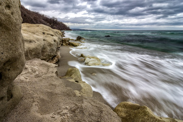 Beauty cloudy, long exposure seascape with slow shutter and waves flowing out.
