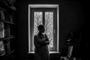 Girl alone at home on self-isolation in black and white