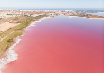 Beautiful aerial wide vibrant summer view of las Salinas de Torrevieja, The Pink Lake Of Torrevieja, pink salt lagoon in Torrevieja, Costa Blanca, province of Alicante, Spain © tsuguliev