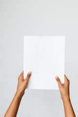 Ethnic model holding a letter size or A4 brochure mockup