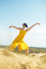 Girls in yellow dress and Gasmask dancing on the sand dunes