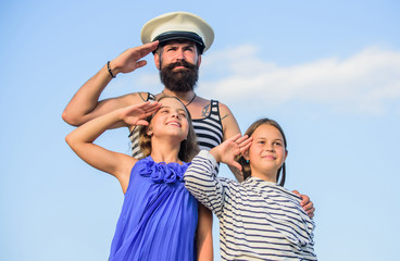 Summer travel concept. Happy family. Dad sailor and daughters outdoors. Captain welcome on board. Marine tour. Sea cruise. Handsome bearded sailor with kids. Travel around world. Travel by sea - obrazy, fototapety, plakaty