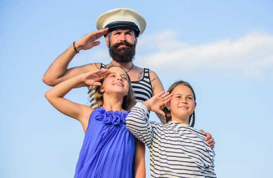Summer travel concept. Happy family. Dad sailor and daughters outdoors. Captain welcome on board. Marine tour. Sea cruise. Handsome bearded sailor with kids. Travel around world. Travel by sea