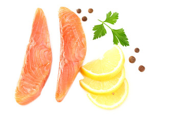 Red fish. Raw salmon fillet with parsley, peppercorns and lemon isolate on white background. Top view