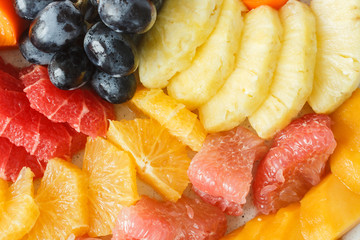 Assorted fruit from grapes, mangoes, oranges, grapefruits and pineapples.
