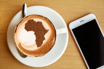 Cup of cappuccino with a picture of Africa