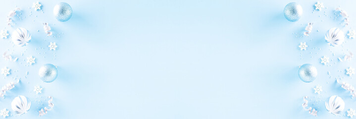 Christmas background concept. Top view of Christmas ball with snowflakes on light blue pastel background, ornament corner border frame header banner.
