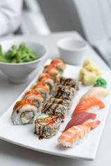 Sushi Roll Set with Seafood on White Plate. Lunch in Japanese Restaurant