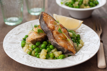Pan Seared Halibut with Sauteed Peas and Lemon Wedge
