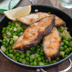 Pan Seared Halibut with Sauteed Peas and Lemon Wedge
