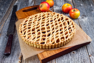 Traditional apple jalousie cake offered as closeup on a modern design wooden board