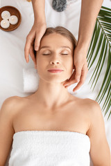 Beautiful woman receiving massage in spa salon