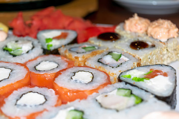 Top view of big set of sushi and rolls. Big dish with different kind of rolls and sushi.