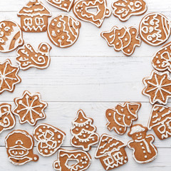 Christmas gingerbread handmade on a white wooden background. A look from above. New Year's concept.