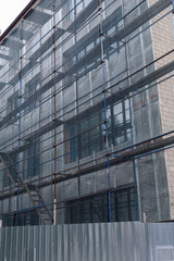 Repair of the facade of the building. Cloth scaffolding