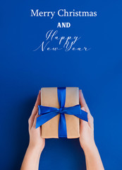 New Year's gift on a blue background, with a beautiful satin ribbon. Christmas. New Year's content.
