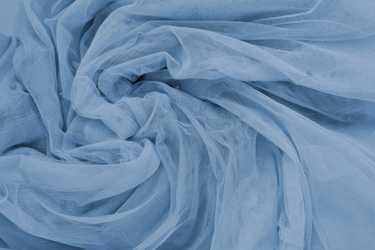 Background of fatin classic blue color twisted fabric. Abstract background, empty template. Top view.