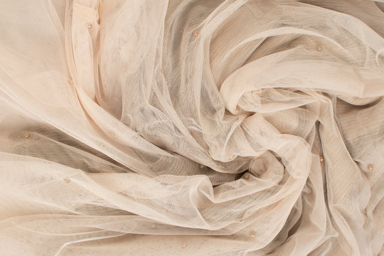 Background of fatin beige color twisted fabric. Abstract background, empty template. Top view.