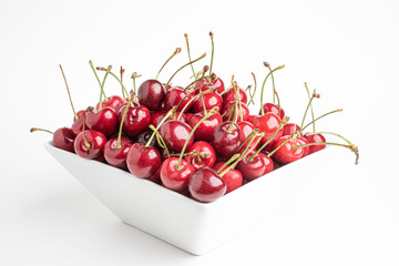 Naklejka na ściany i meble Fresh Cherries In A Square Porcelain White Bowl