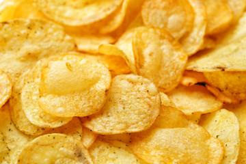 Tasty potato chips as background