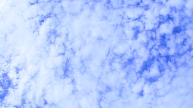 Looking up at a geoengineered sky. Layers of fake clouds drift in the wind. Bottom layer of homomutatus clouds that have spread out and the top layer holds chemtrails that have just been sprayed.