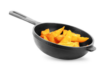 Fried potato wedges in the pan isolated on white