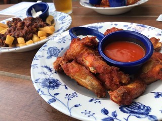 Popular pub foods, fried chicken wings and barbecue sauce