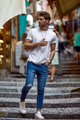Handsome man in daily outfit walking on the street