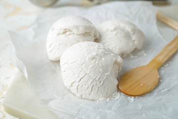 Tasty coconut ice-cream on table