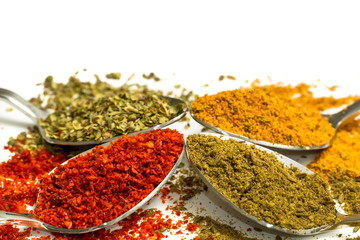 various spices. red pepper, black pepper and curry on white background