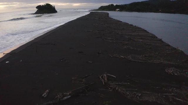 Aerial of a beautiful blacksand beach on the Pacific coast during Sunset, Colombia.