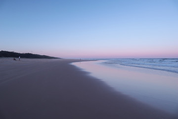 Fototapeta premium Sunset colours reflected on the sand of an empty beach