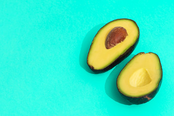 Organic avocado on turquoise background