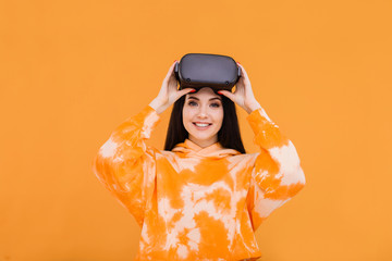 Portrait of beautiful woman in glasses of virtual reality. Augmented reality, future technology concept. VR. Bright trendy background. Free space for text.