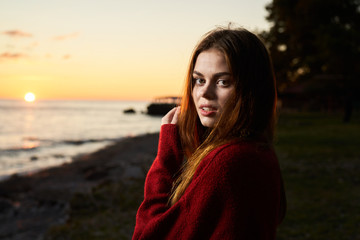 portrait of young woman on the beach at sunset