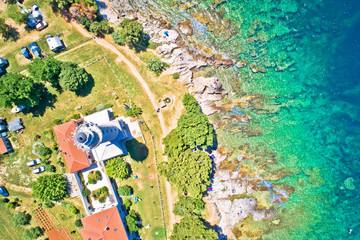 Fototapeta premium Savudrija lighthouse and turquoise crystal clear rocky beach aerial view